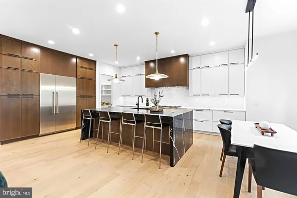 a kitchen with stainless steel appliances kitchen island granite countertop a sink and cabinets