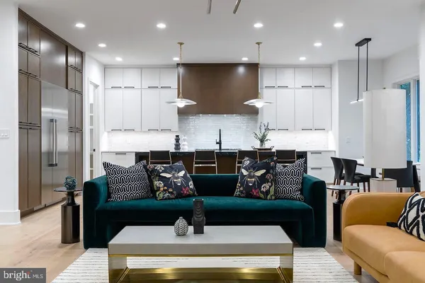 a kitchen with stainless steel appliances granite countertop a refrigerator and a stove