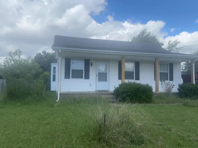 a view of a house next to a yard