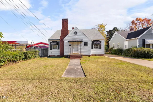 a front view of house with yard and green space