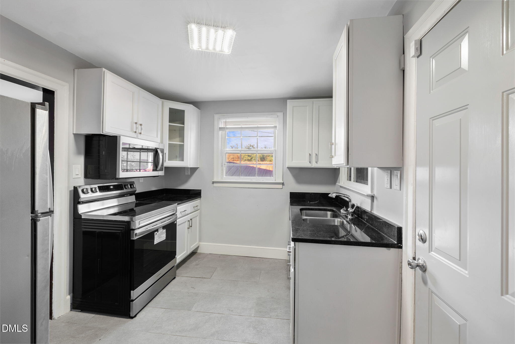 109 Lincoln Court Raleigh, NC 27610 - Photo 14 of 27 a kitchen with granite countertop a stove sink and refrigerator