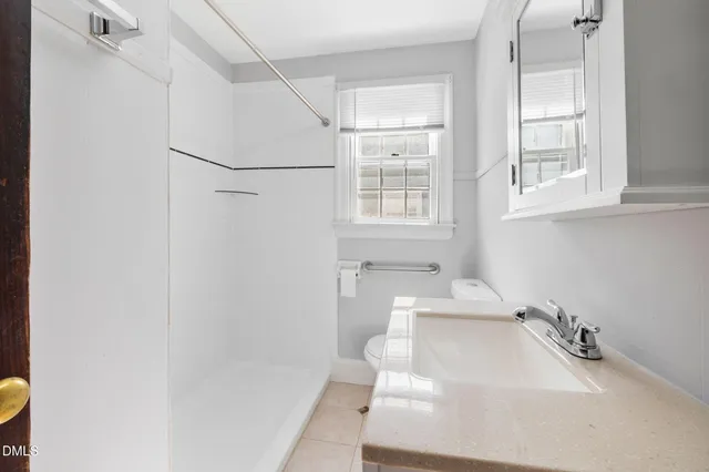 a bathroom with a sink window and tub