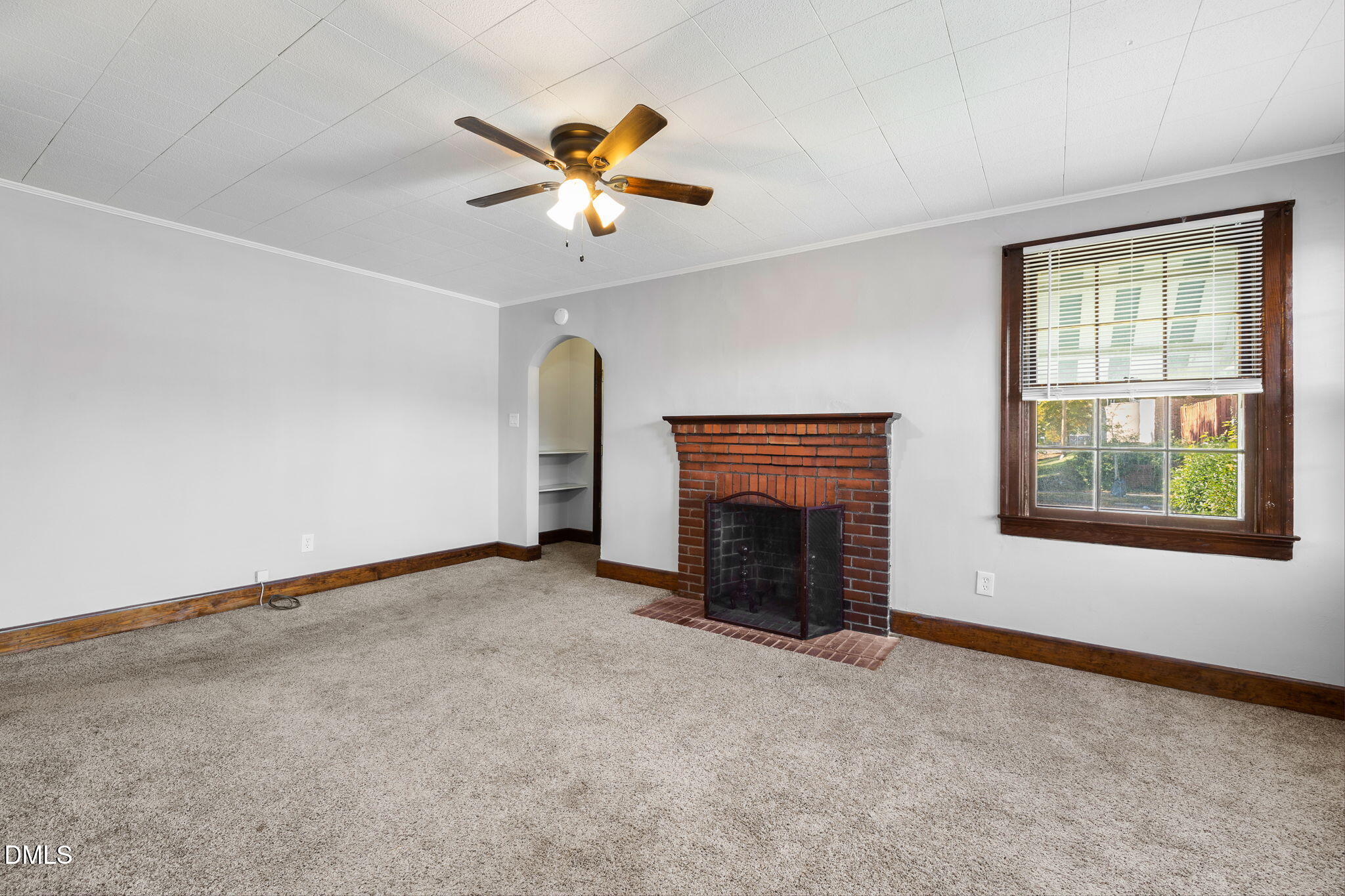 109 Lincoln Court Raleigh, NC 27610 - Photo 4 of 27 an empty room with windows fireplace and fan
