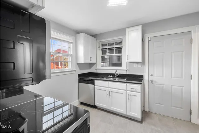 a kitchen with stainless steel appliances granite countertop a stove and a sink