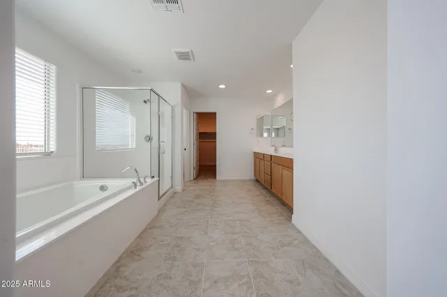 a spacious bathroom with a bathtub and a shower