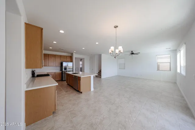 a view of a kitchen with a sink and chandelier