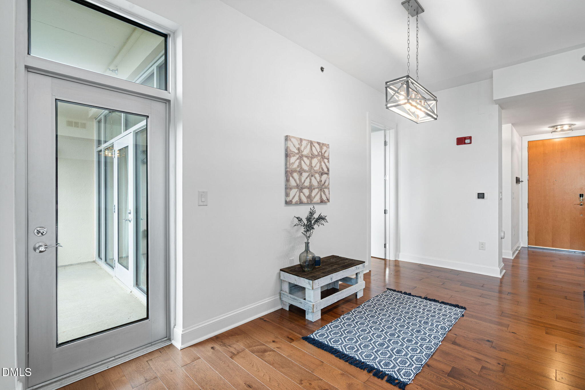 618 North Boylan Avenue, Unit 812 Raleigh, NC 27603 - Photo 5 of 35 a view of a hallway with wooden floor and a chandelier