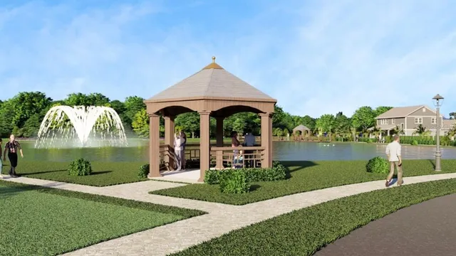 an aerial view of a house with a yard lake and mountain view in back