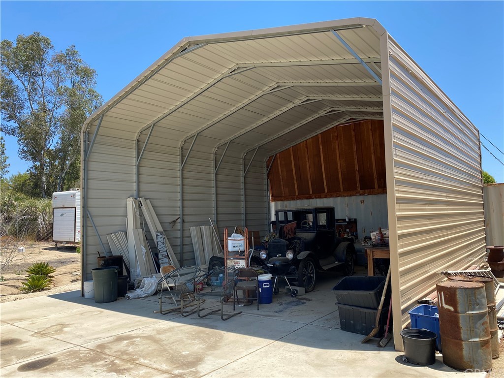 39300 Liefer Road Temecula, CA 92591 - Photo 4 of 28 a view of a patio with table and chairs with wooden fence