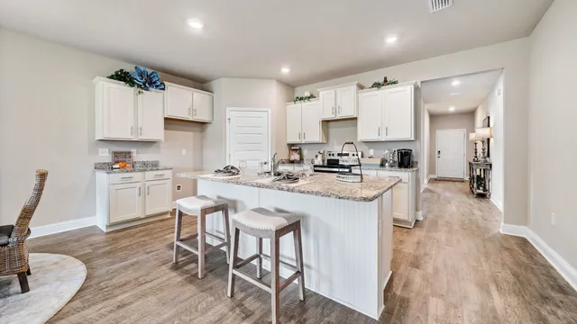 a kitchen with appliances a sink and cabinets