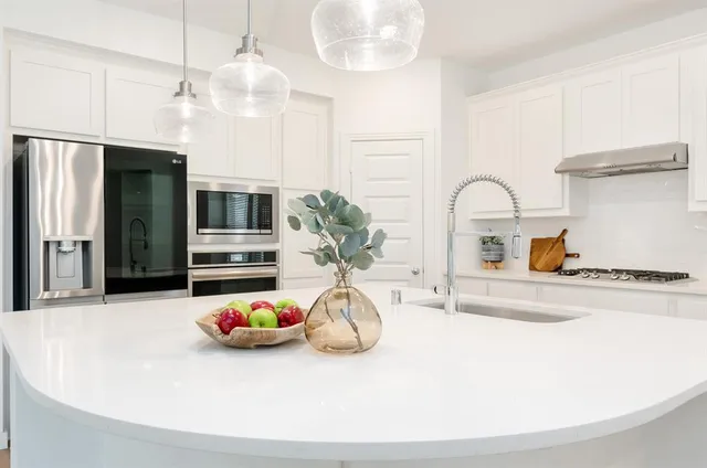 a close view of dining table chairs and chandelier