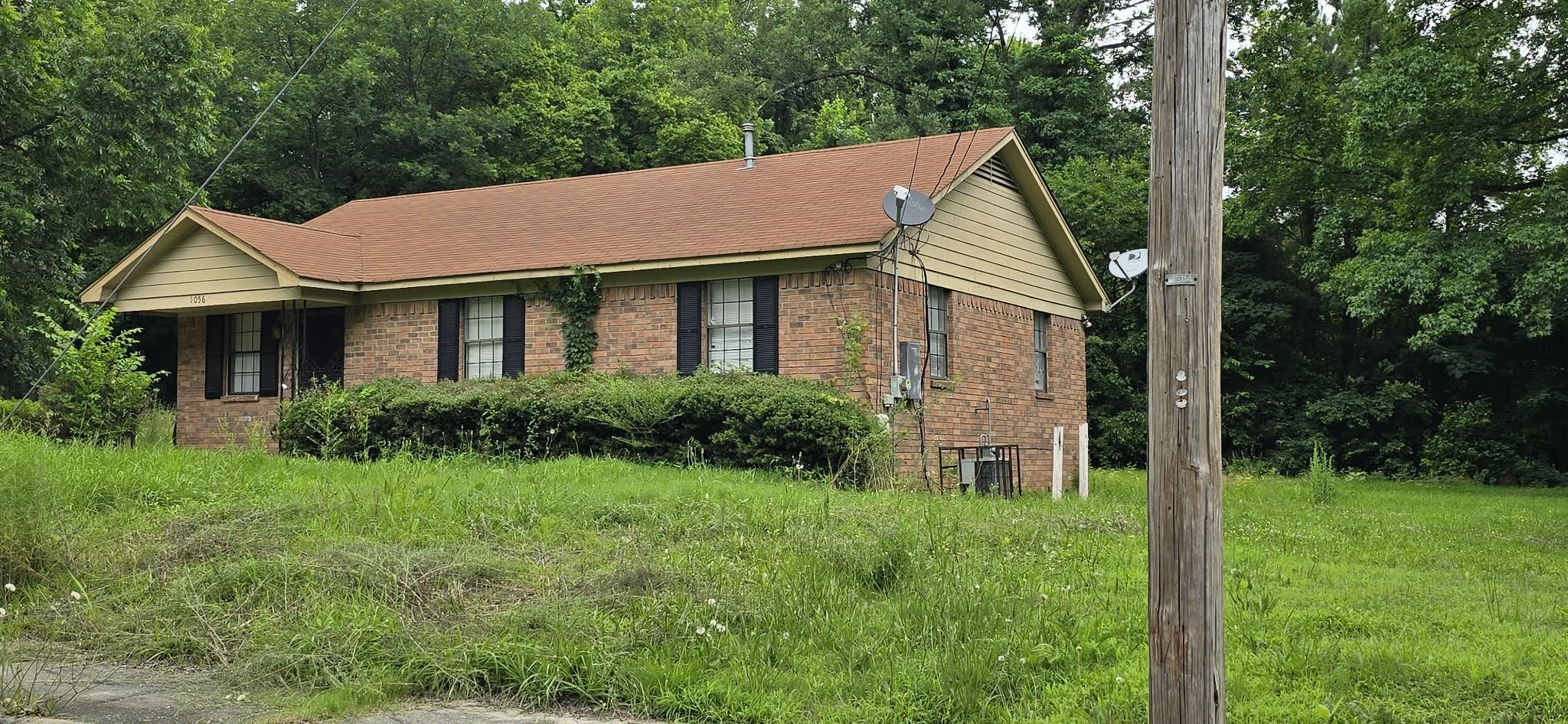 1056 Walk Road Memphis, TN 38109 - Photo 3 of 3 Brick exterior residence with a contrasting shingle roof