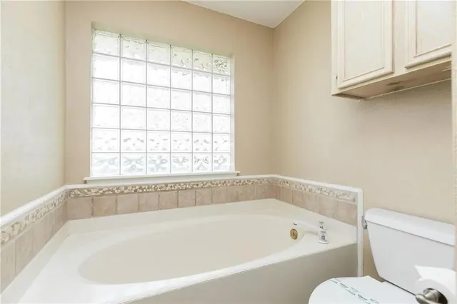 a white bath tub sitting next to a window