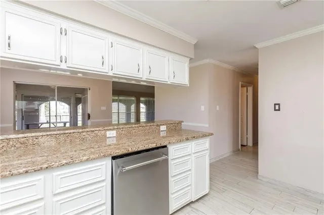 a kitchen with granite countertop a sink and cabinets