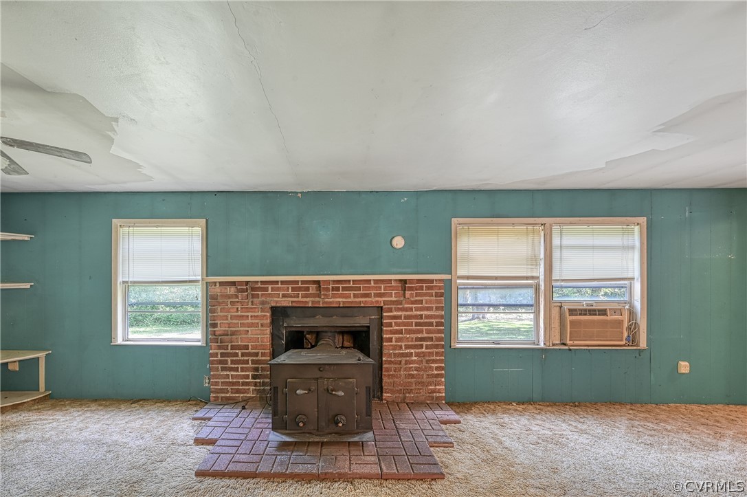 13287 Cross County Road Mineral, VA 23117 - Photo 18 of 27 an empty room with a fireplace and windows
