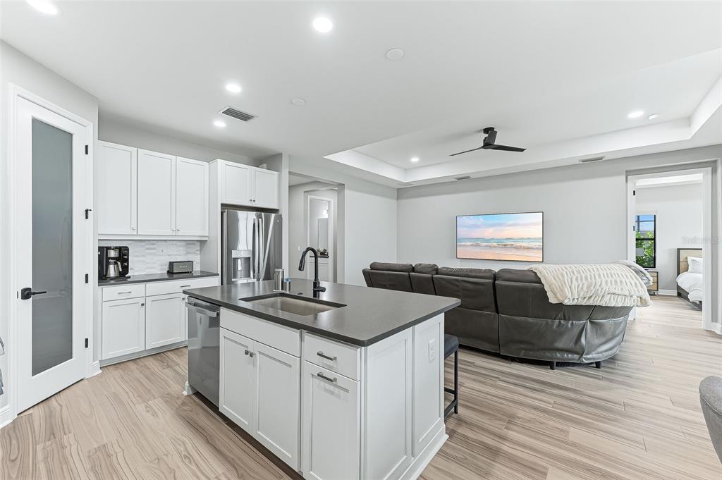 4191 Pegasus Way Naples, FL 34120 - Photo 13 of 48 a kitchen with stainless steel appliances granite countertop a sink dishwasher a stove and a refrigerator with wooden floor