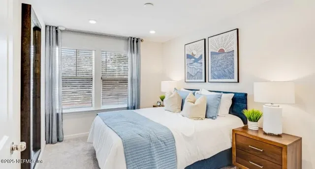 a bedroom with bed and window