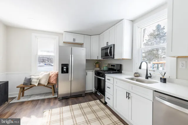 a kitchen with a refrigerator and a sink