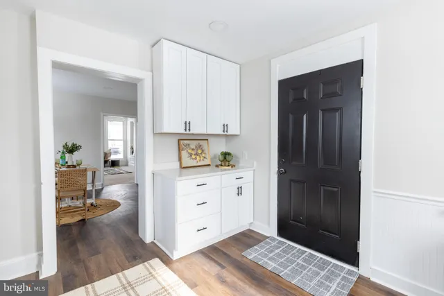 a hallway with a dresser and a window