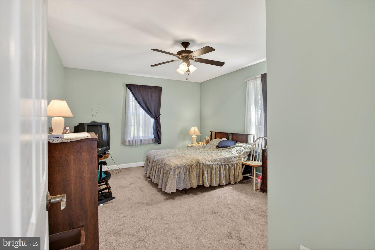 1751 Orchard Road Mount Jackson, VA 22842 - Photo 11 of 30 a bedroom with bed and a chandelier