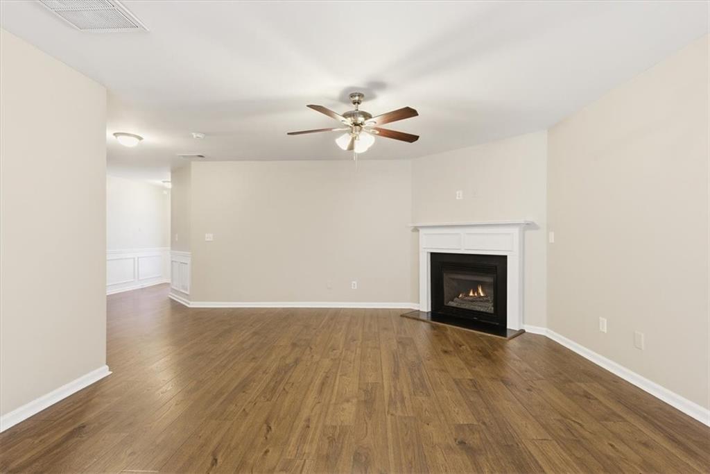 342 Hidden Creek Lane Canton, GA 30114 - Photo 11 of 30 an empty room with a fireplace and wooden floor