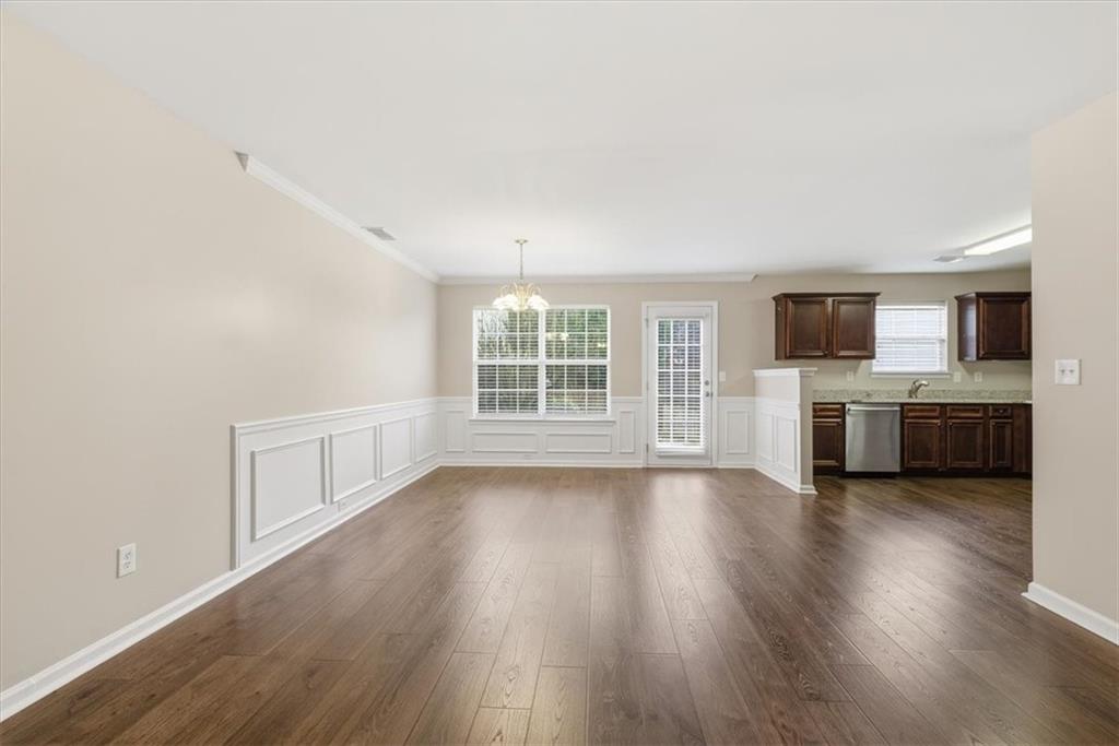 342 Hidden Creek Lane Canton, GA 30114 - Photo 12 of 30 a view of an empty room with a window and wooden floor