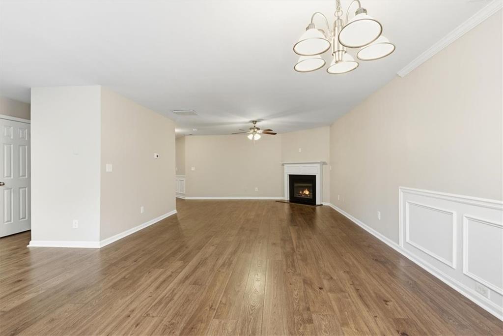 342 Hidden Creek Lane Canton, GA 30114 - Photo 14 of 30 an empty room with wooden floor and ceiling fan