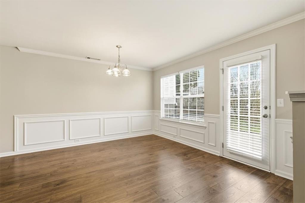 342 Hidden Creek Lane Canton, GA 30114 - Photo 15 of 30 an empty room with wooden floor and windows