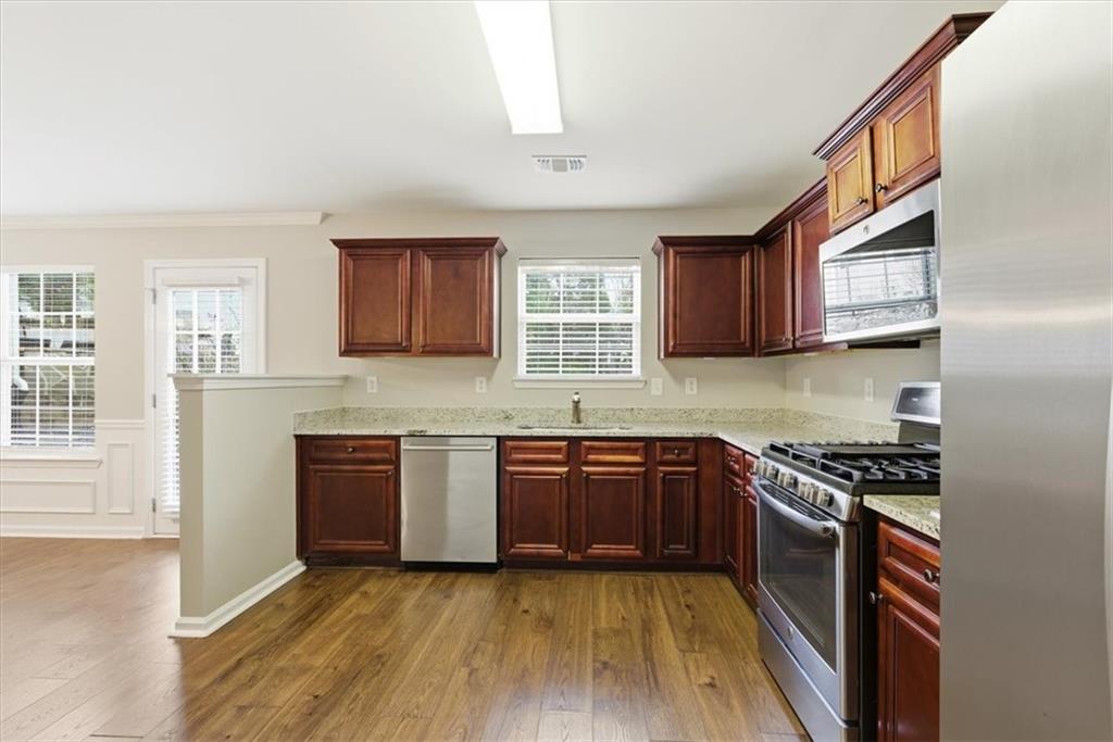 342 Hidden Creek Lane Canton, GA 30114 - Photo 17 of 30 a kitchen with stainless steel appliances granite countertop wooden cabinets stove top oven and sink