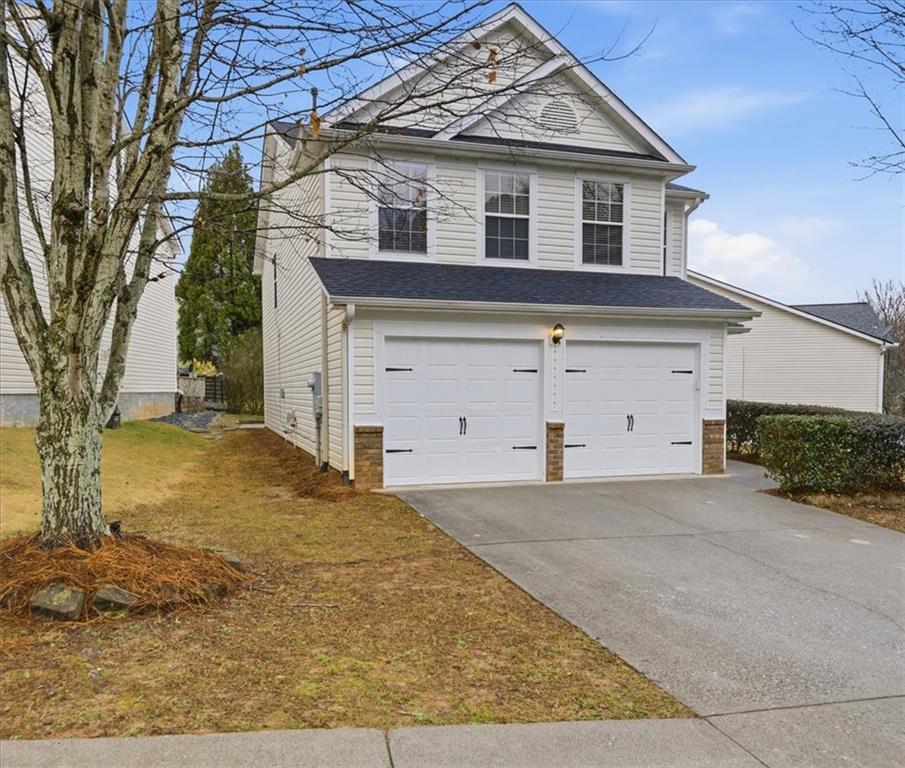 342 Hidden Creek Lane Canton, GA 30114 - Photo 2 of 30 a front view of a house with a yard and garage