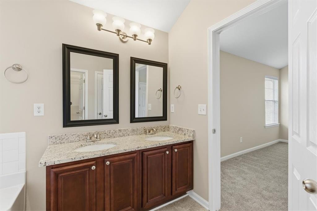 342 Hidden Creek Lane Canton, GA 30114 - Photo 23 of 30 a bathroom with a granite countertop sink and a mirror