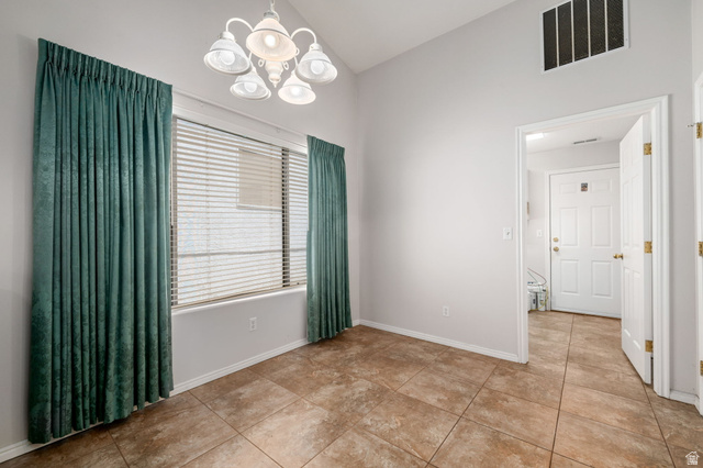 39 North Valley View Drive, Unit 51 St. George, UT 84770 - Photo 14 of 25 Spacious room featuring tile flooring, a large window with blinds and drapery, a ceiling-mounted light fixture, and light-toned wall paint