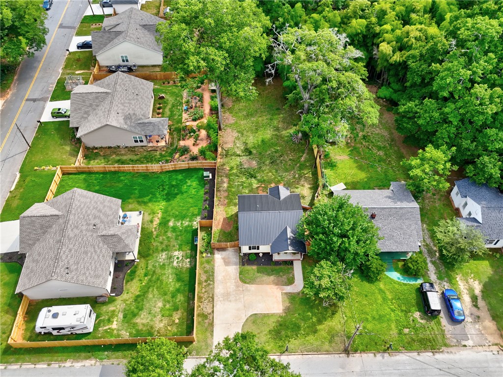 1020 Elizabeth Street Anderson, SC 29624 - Photo 21 of 22 An aerial perspective reveals the property's generous yard space, a fenced-in lawn, and mature trees, alongside neighboring residences.