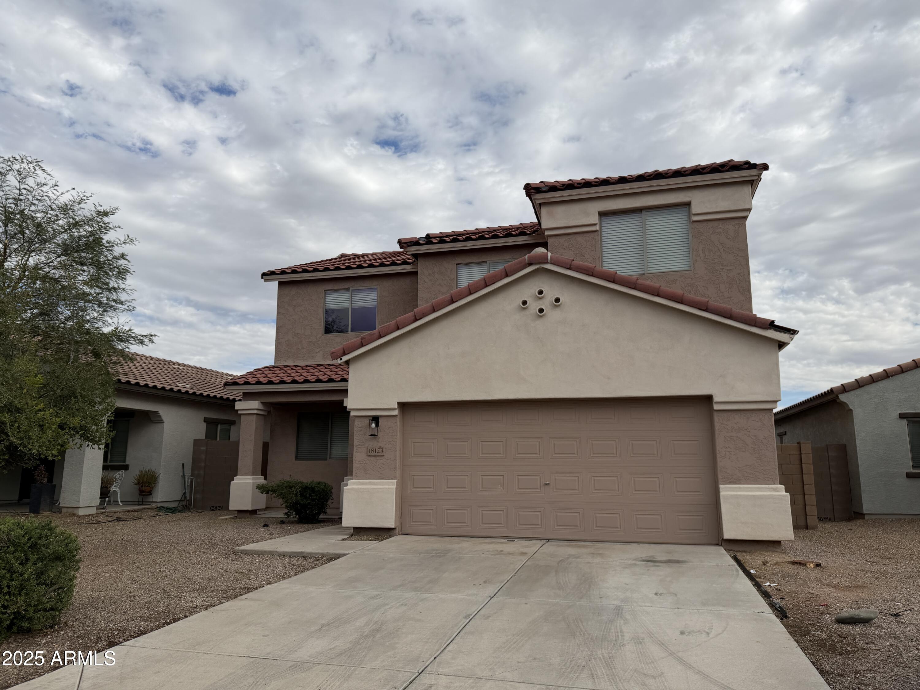 18123 North Madison Road Maricopa, AZ 85139 - Photo 1 of 26 a front view of a house with a garage