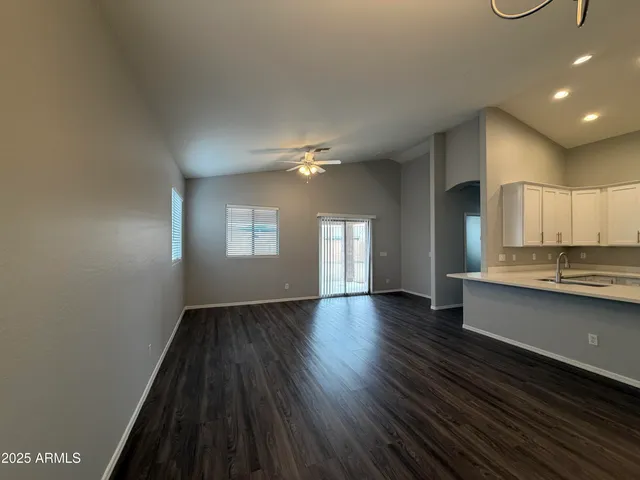 a view of a kitchen with a sink and wooden floor