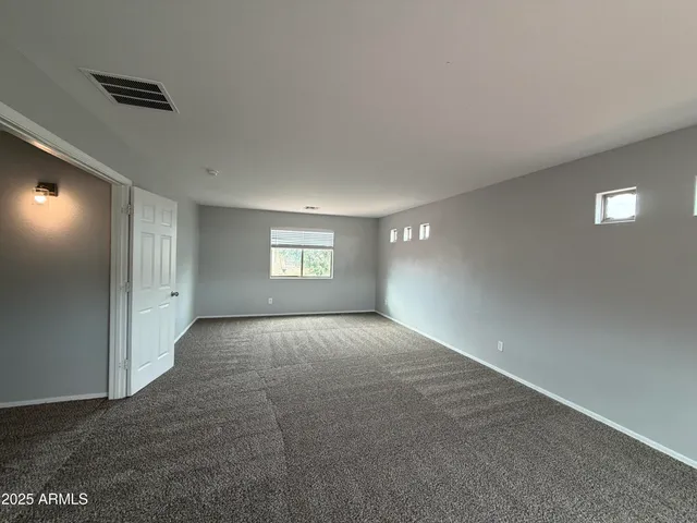 a view of an empty room and a window