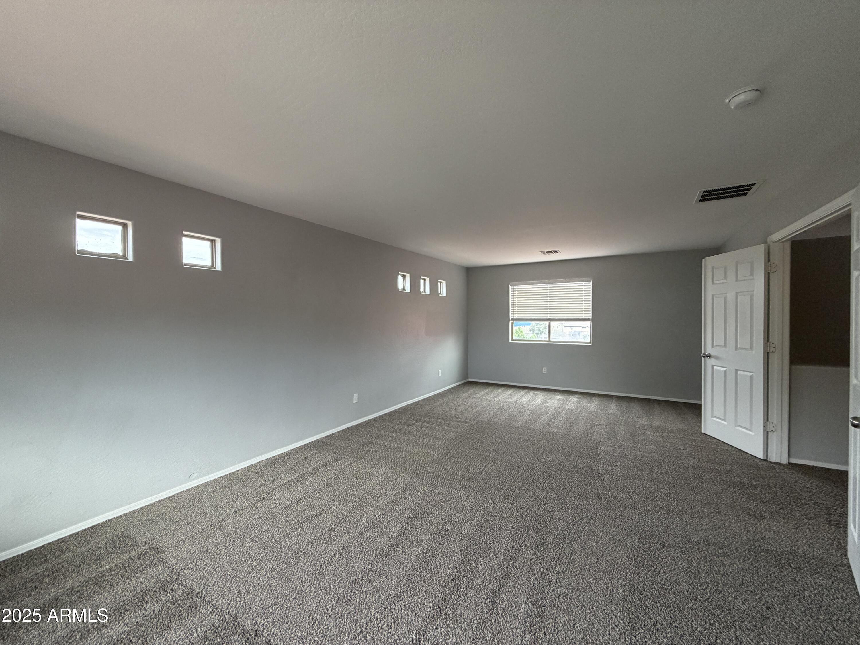 18123 North Madison Road Maricopa, AZ 85139 - Photo 19 of 26 a view of an empty room with a window and a fireplace