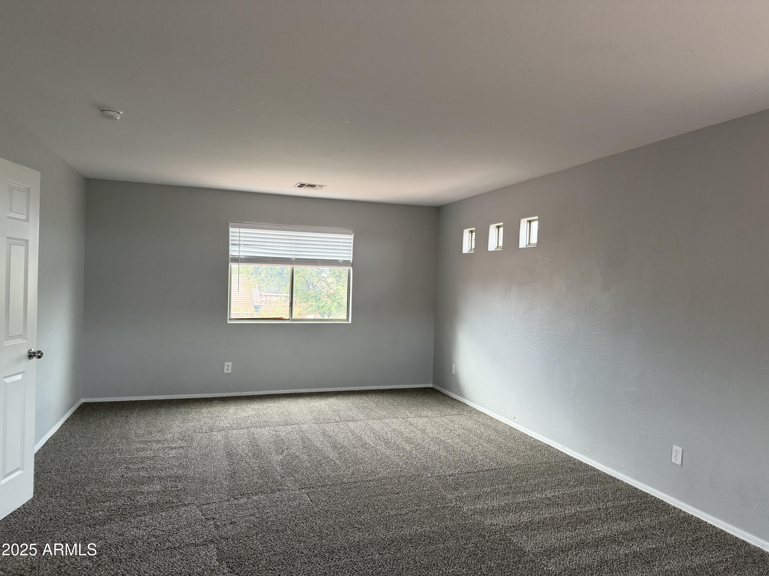 18123 North Madison Road Maricopa, AZ 85139 - Photo 20 of 26 a view of an empty room with a window
