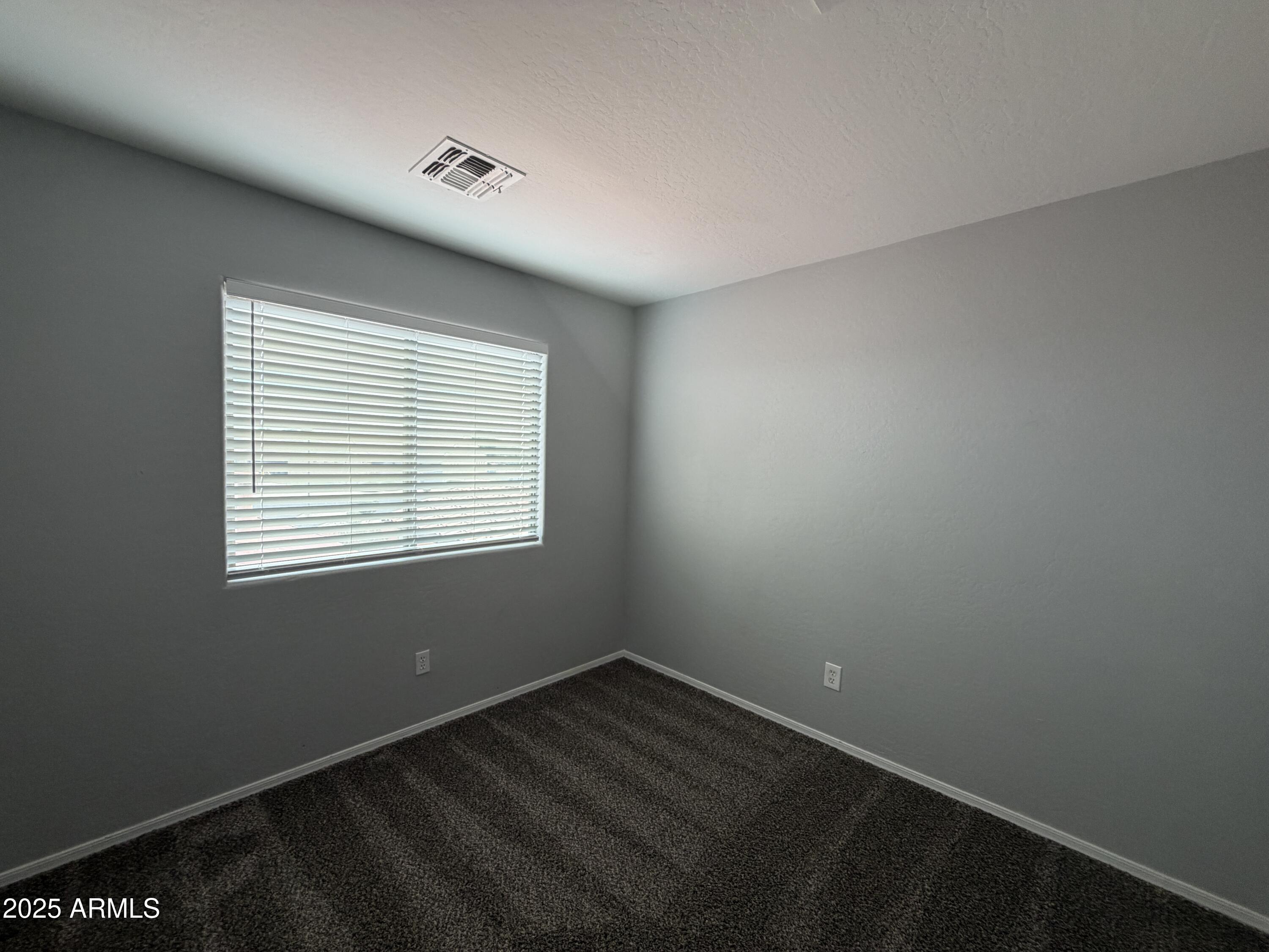 18123 North Madison Road Maricopa, AZ 85139 - Photo 21 of 26 an empty room with a window