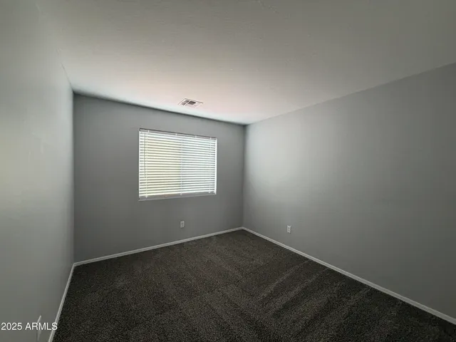 an empty room with a empty space and a window