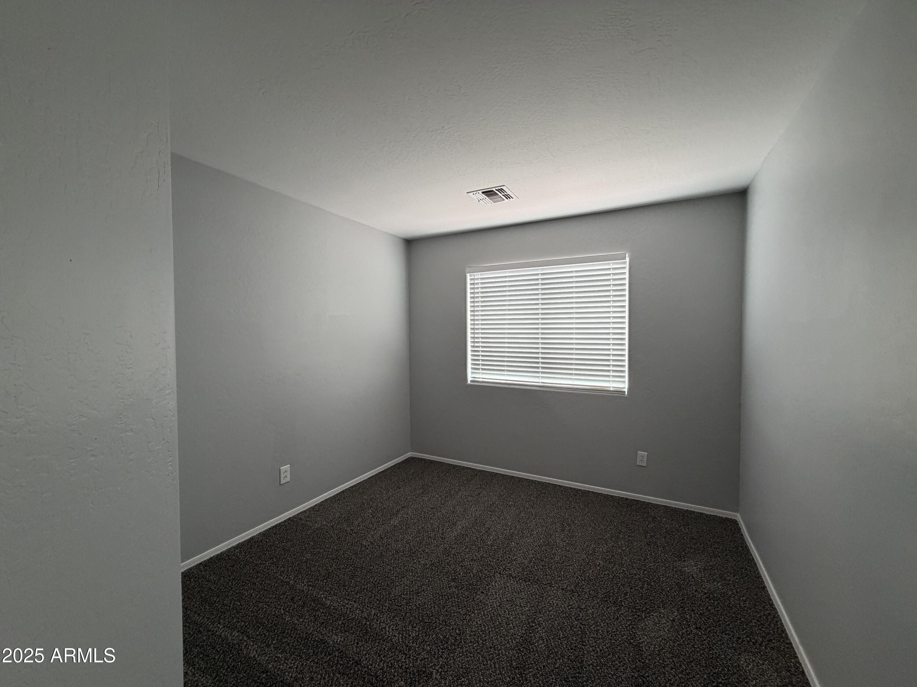 18123 North Madison Road Maricopa, AZ 85139 - Photo 24 of 26 an empty room with a empty space and a window