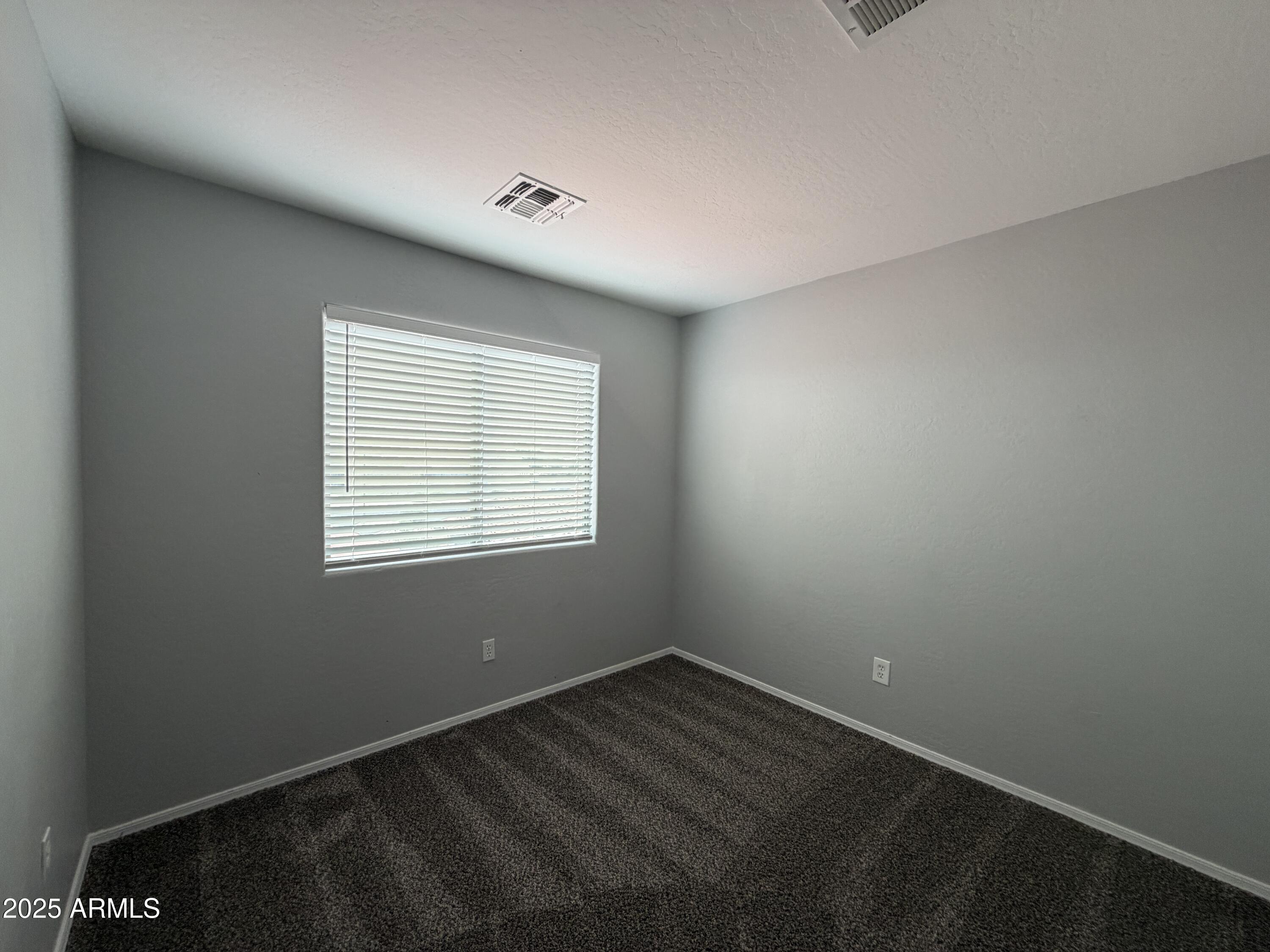 18123 North Madison Road Maricopa, AZ 85139 - Photo 25 of 26 an empty room with a window