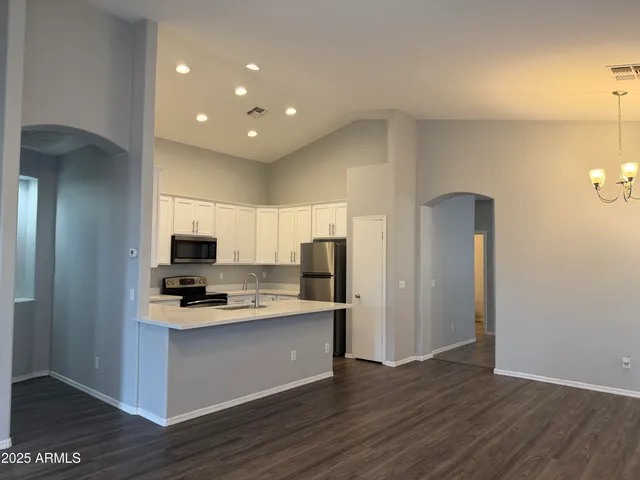 a kitchen with a refrigerator and a stove top oven