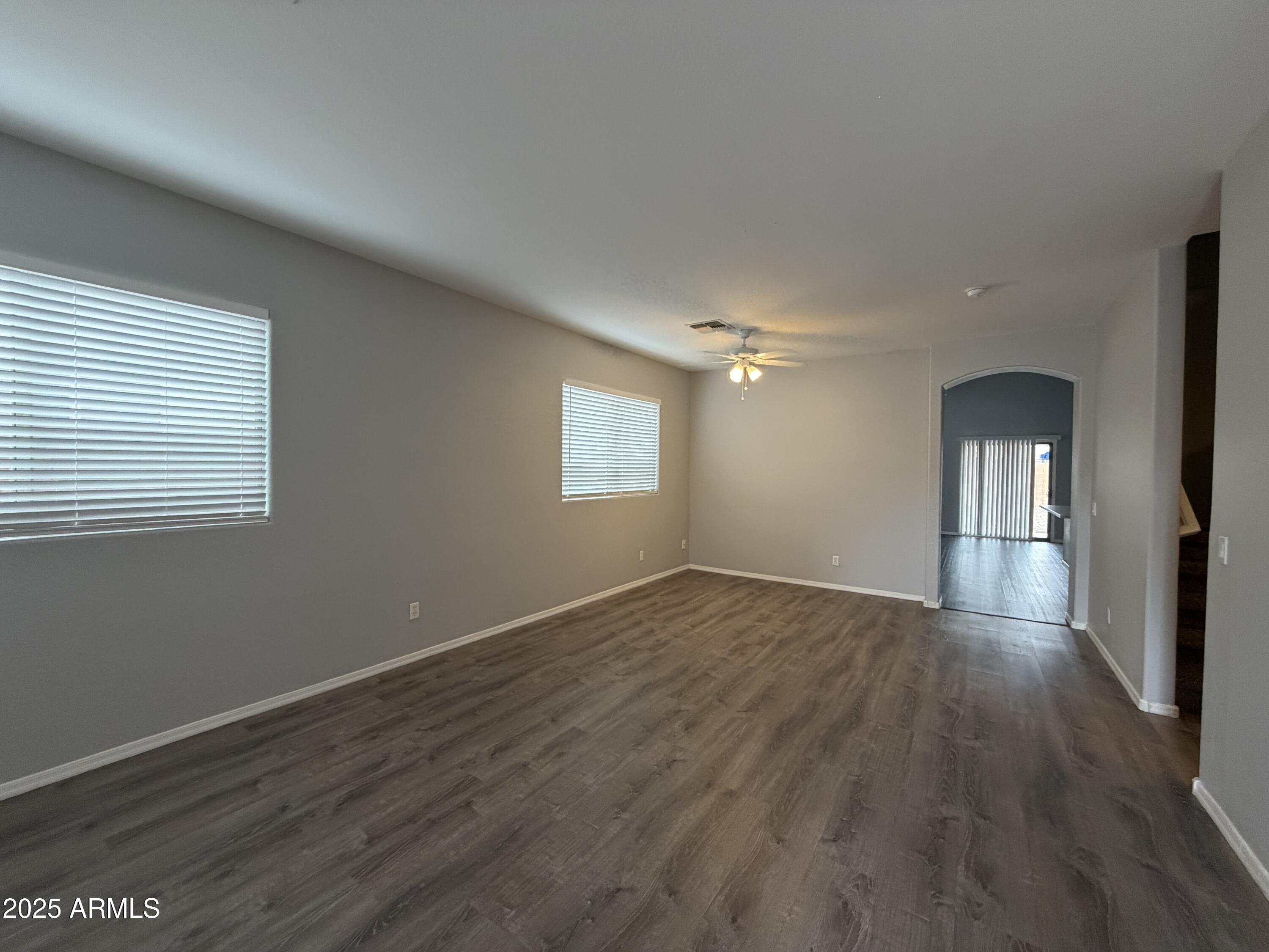 18123 North Madison Road Maricopa, AZ 85139 - Photo 4 of 26 a view of empty room with window and wooden floor