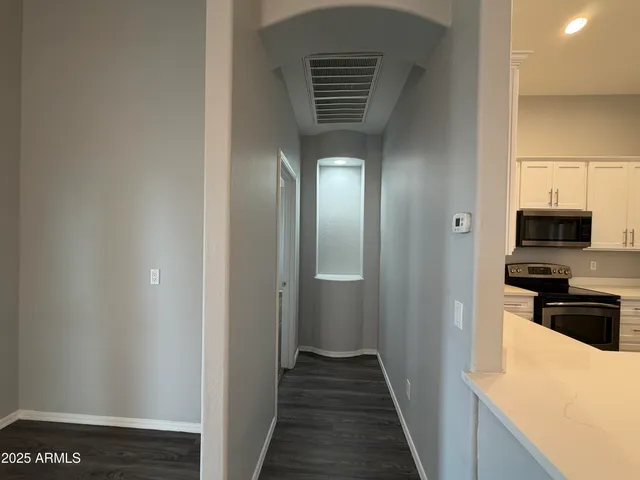 a view of a kitchen from the hallway