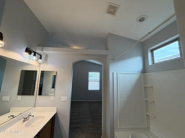 a bathroom with a double vanity sink and mirror