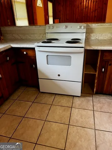 a kitchen with a stove a sink and a cabinets