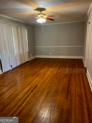 a view of a room with wooden floor
