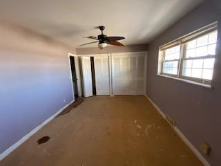 682 County Road 1038 Muleshoe, TX 79347 - Photo 6 of 23 an empty room with windows and fan