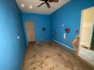 682 County Road 1038 Muleshoe, TX 79347 - Photo 10 of 23 an empty room with a ceiling fan and carpet